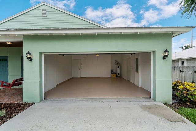 garage featuring electric panel and water heater