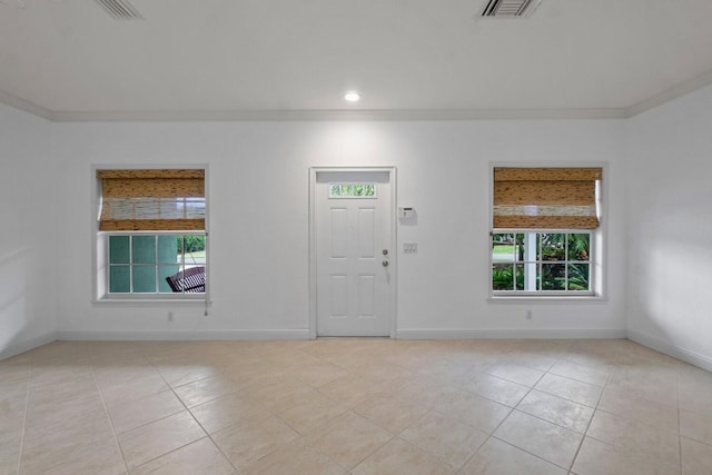 unfurnished room with light tile patterned flooring and ornamental molding