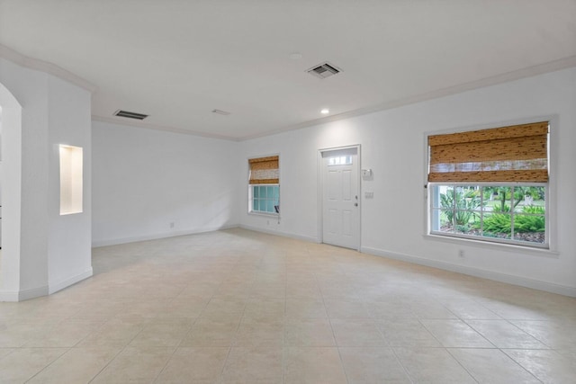 spare room with light tile patterned floors and ornamental molding