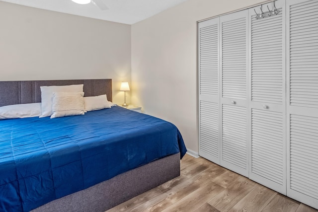 bedroom featuring a closet, light hardwood / wood-style flooring, and ceiling fan