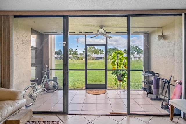 interior space featuring tile patterned flooring, ceiling fan, and floor to ceiling windows