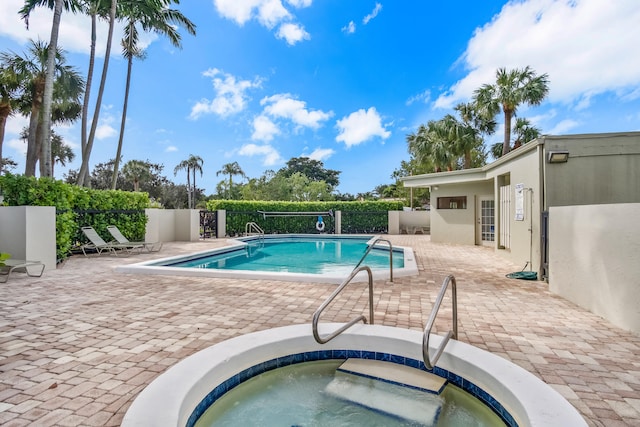 view of pool with an in ground hot tub and a patio