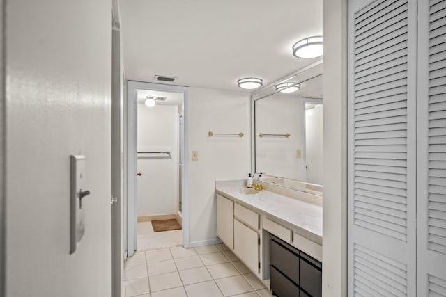 bathroom with tile patterned flooring, vanity, and a shower with shower door