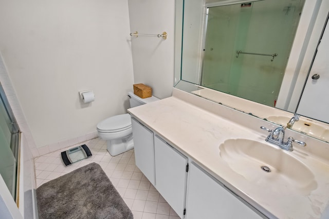 bathroom featuring tile patterned flooring, vanity, and toilet