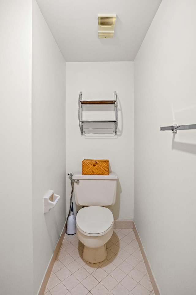 bathroom featuring tile patterned flooring and toilet