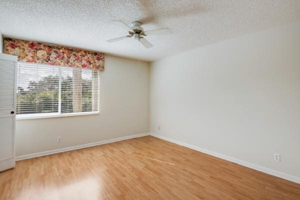 433 Pine Glen Ln Unit A2, Greenacres, FL 33463 - empty room with ceiling fan, a textured ceiling, and light wood finished floors