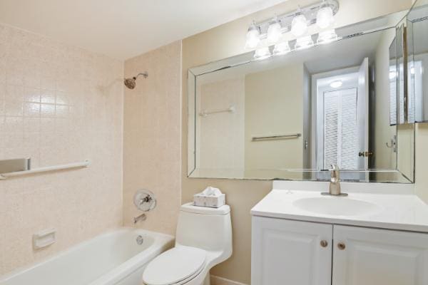 full bathroom featuring vanity, toilet, and tiled shower / bath