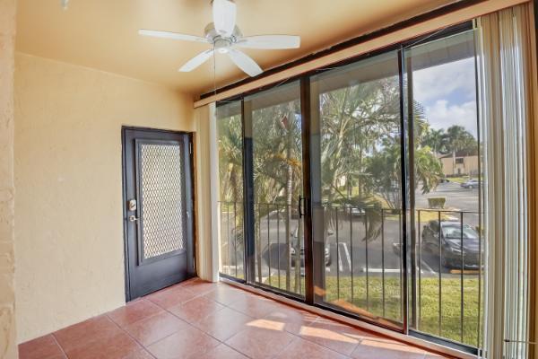 doorway with tile patterned floors, plenty of natural light, and ceiling fan