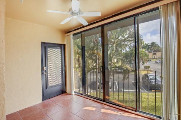 433 Pine Glen Ln Unit A2, Greenacres, FL 33463 - doorway to outside featuring tile patterned flooring, plenty of natural light, and ceiling fan