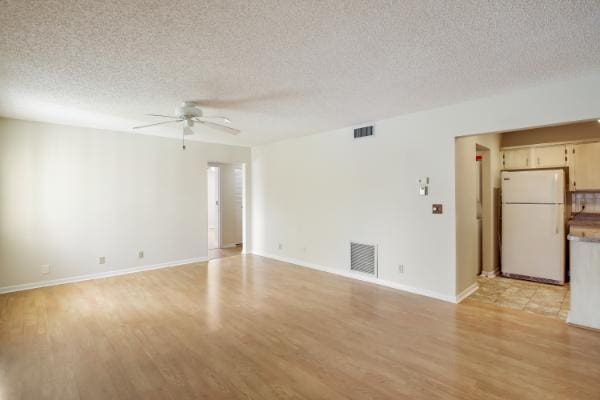 433 Pine Glen Ln Unit A2, Greenacres, FL 33463 - spare room with a ceiling fan, light wood-style floors, and a textured ceiling