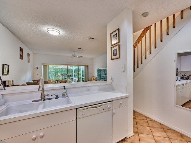 kitchen with ceiling fan, dishwasher, sink, a textured ceiling, and light tile patterned floors