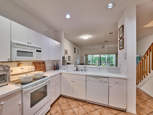 kitchen with white cabinetry, sink, light tile patterned floors, white appliances, and ceiling fan