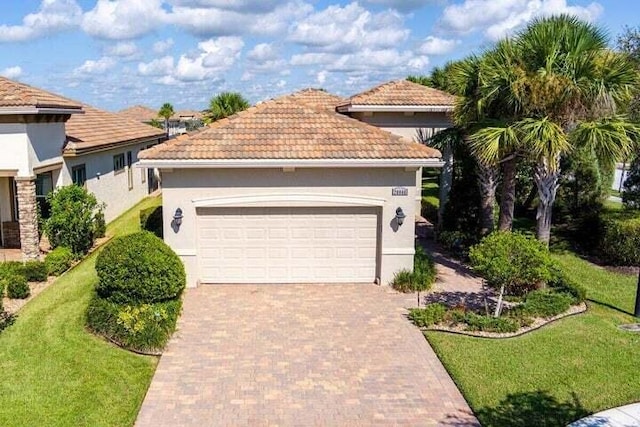 mediterranean / spanish-style home with a garage and a front yard