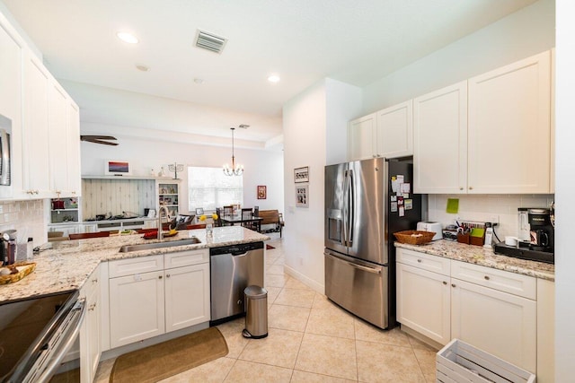 kitchen with sink, white cabinets, and appliances with stainless steel finishes