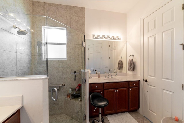 bathroom with vanity and a shower with shower door