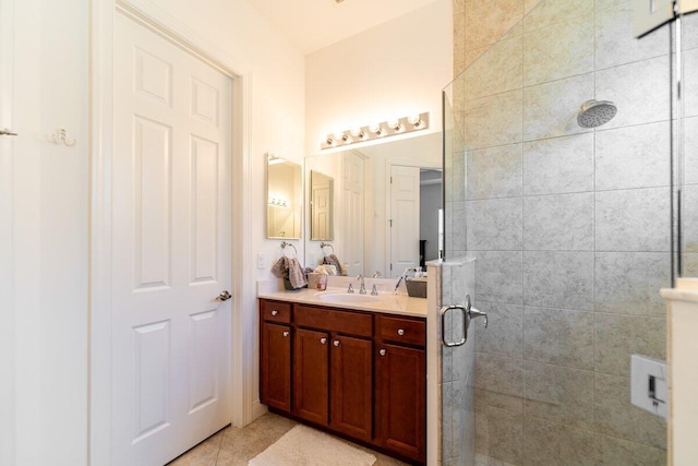 bathroom with tile patterned floors, vanity, and an enclosed shower