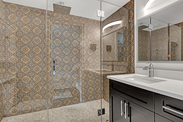 bathroom with tile walls, vanity, and an enclosed shower