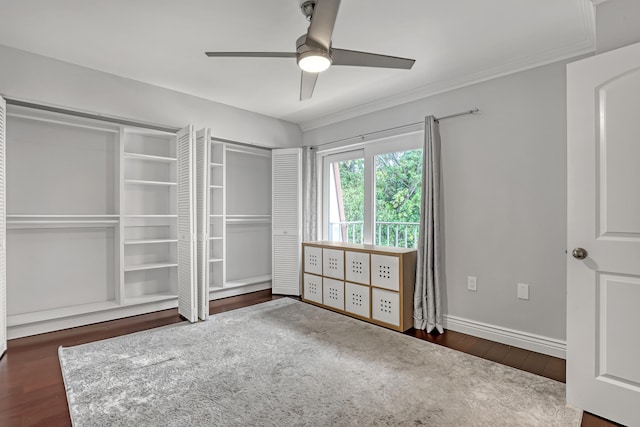 unfurnished bedroom with a closet, ceiling fan, crown molding, and dark wood-type flooring