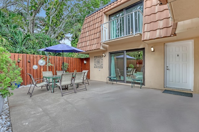 view of patio featuring a balcony