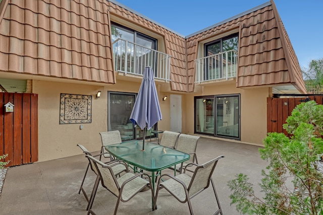 back of property with a patio area and a balcony