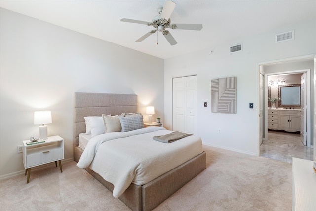 bedroom with baseboards, visible vents, a closet, and light colored carpet