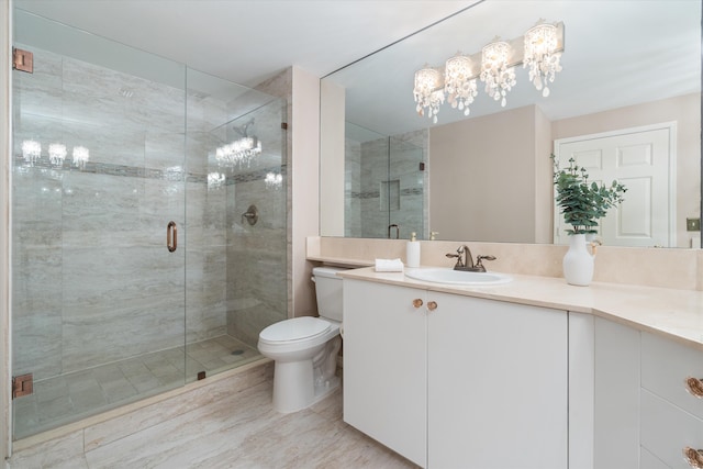 bathroom featuring toilet, a stall shower, and vanity