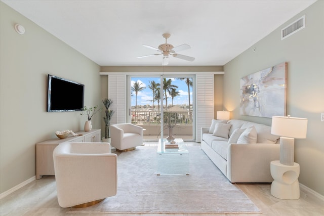 living area with visible vents, ceiling fan, and baseboards