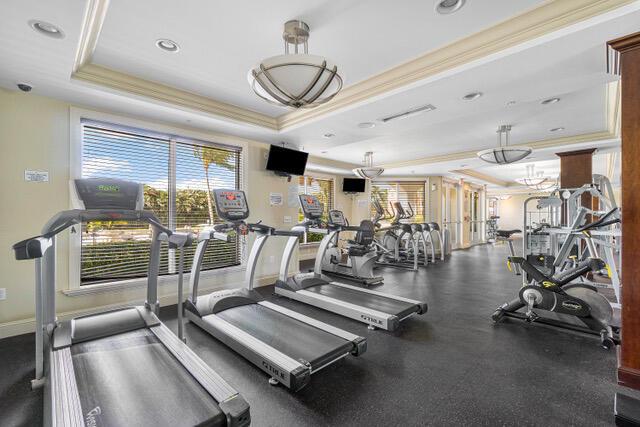 806 E Windward Way Unit 212, Lantana, FL 33462 - exercise room with ornamental molding, a raised ceiling, plenty of natural light, baseboards, and recessed lighting