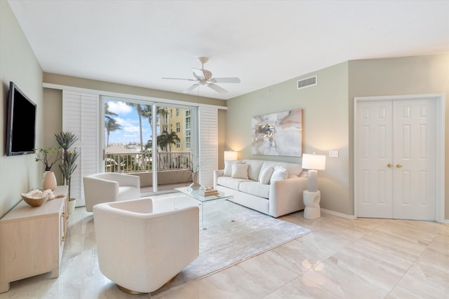 living room featuring ceiling fan, visible vents, and baseboards