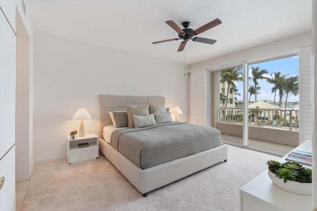 bedroom featuring access to exterior, light colored carpet, baseboards, and a ceiling fan