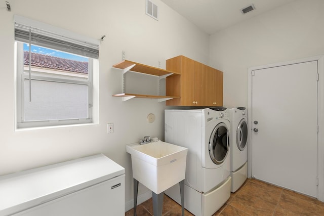 clothes washing area featuring washing machine and dryer and sink