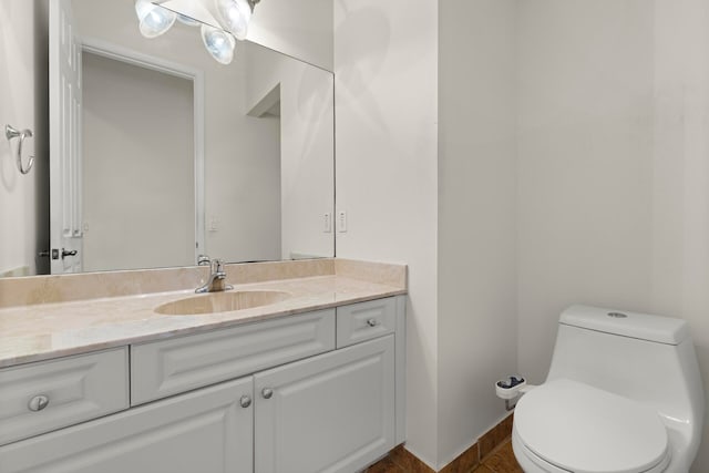 bathroom featuring tile patterned flooring, vanity, and toilet