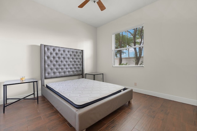 bedroom featuring dark hardwood / wood-style floors, ceiling fan, and lofted ceiling