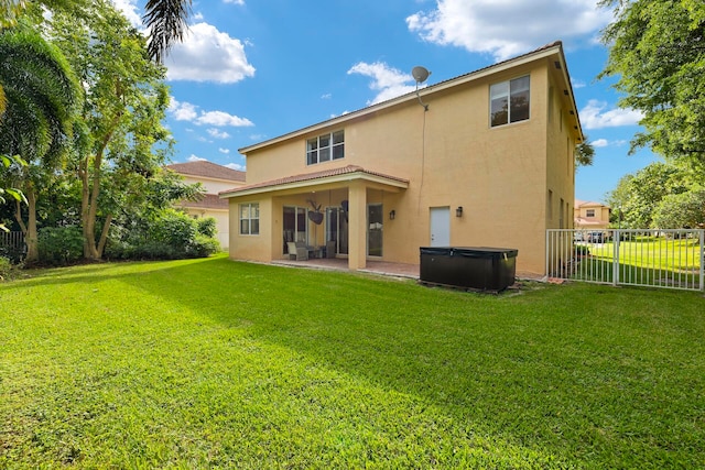 rear view of house with a yard and a patio