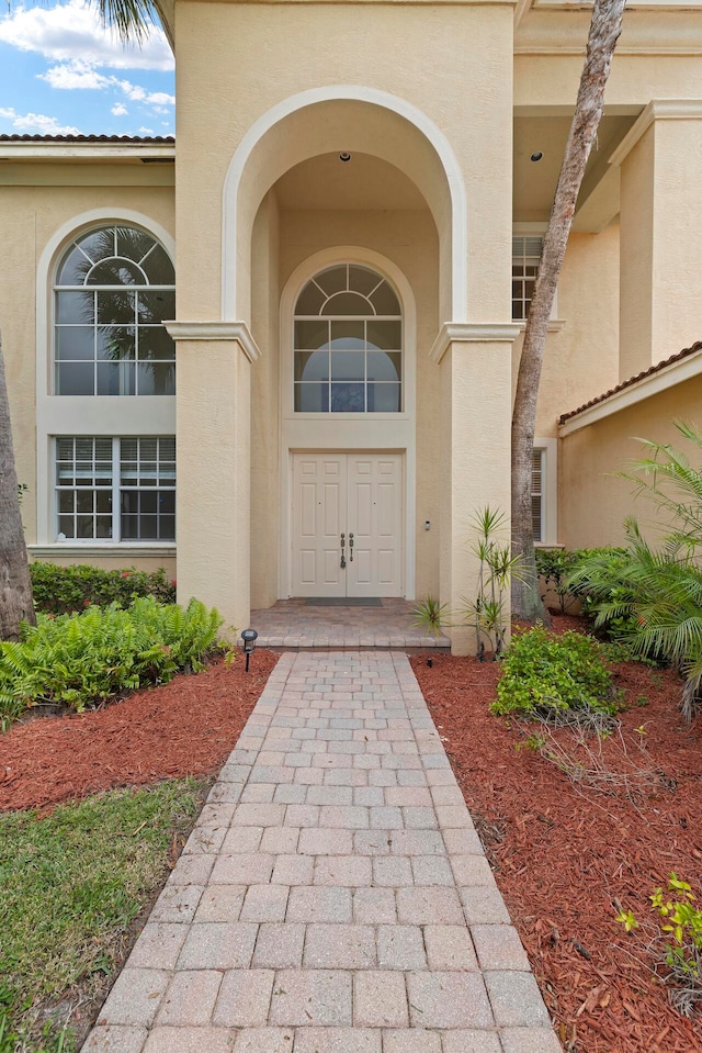 property entrance with stucco siding