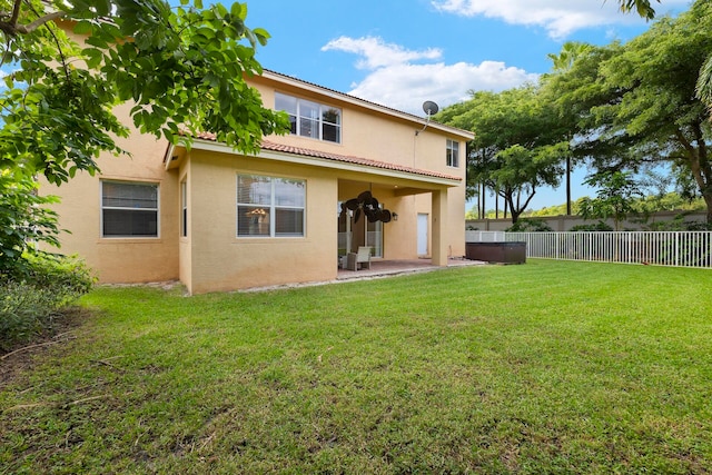 rear view of house with a patio area and a lawn