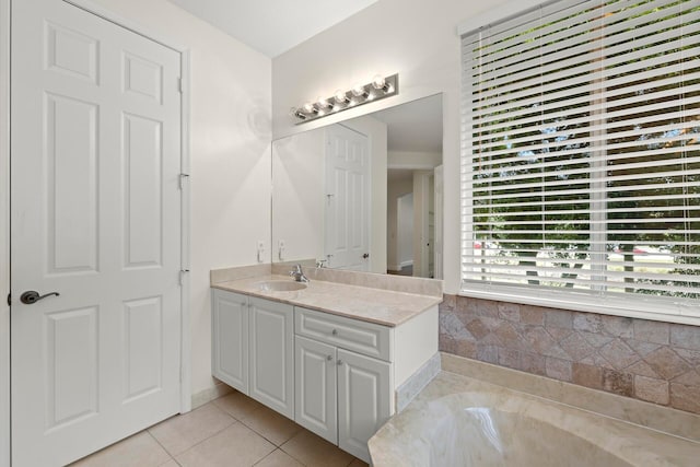 bathroom featuring a washtub, vanity, and tile patterned floors