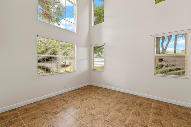 empty room with a high ceiling and a wealth of natural light