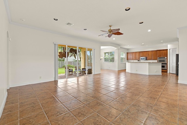 unfurnished living room featuring ceiling fan, ornamental molding, and light tile patterned floors