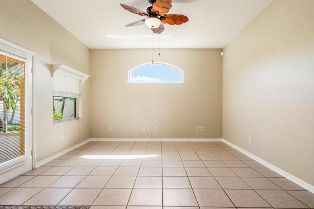 tiled spare room with ceiling fan