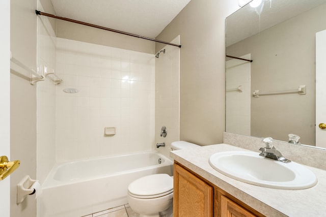 full bathroom with vanity, tile patterned flooring, tiled shower / bath, and toilet