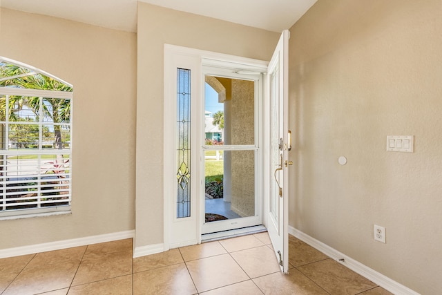 doorway featuring plenty of natural light and light tile patterned floors