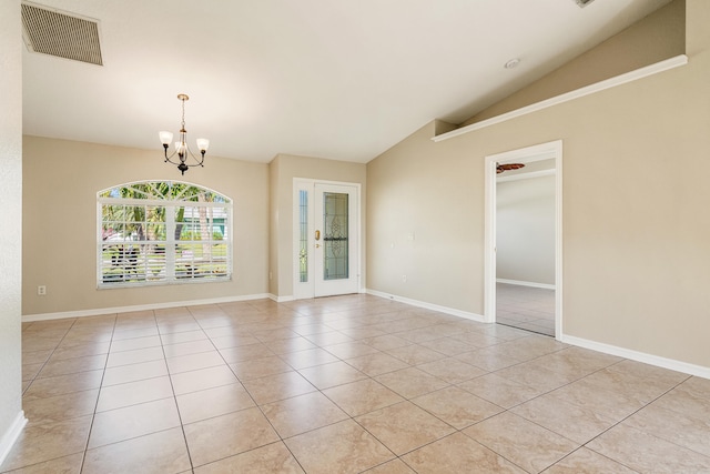 empty room featuring light tile patterned floors, vaulted ceiling, french doors, and a notable chandelier