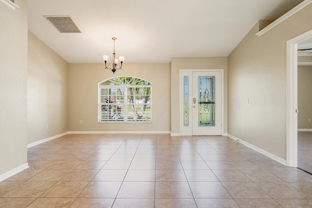 interior space with light tile patterned floors and a notable chandelier