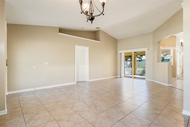 unfurnished room with lofted ceiling, light tile patterned floors, and a chandelier