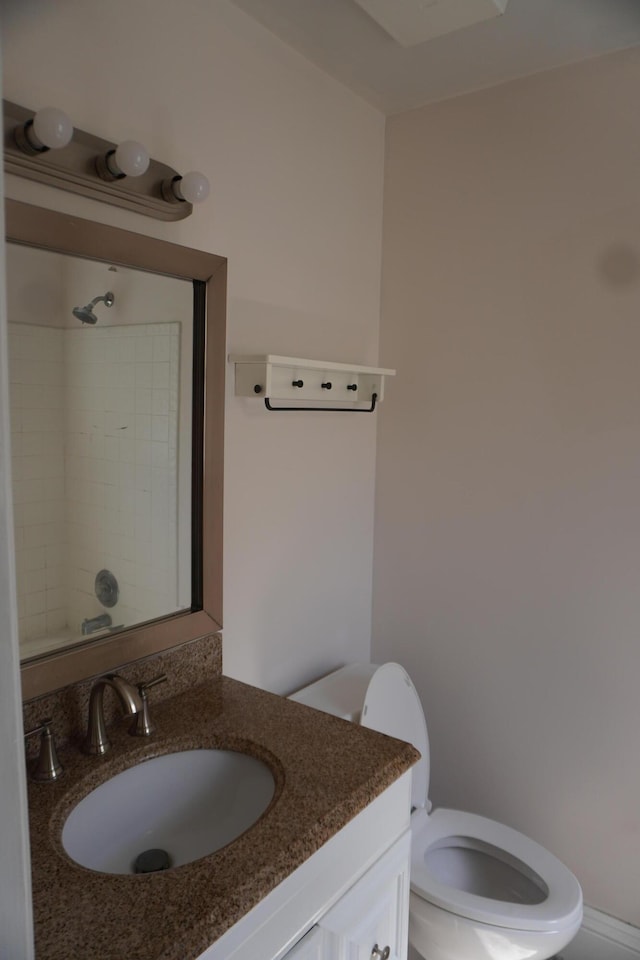 bathroom with vanity, toilet, and walk in shower