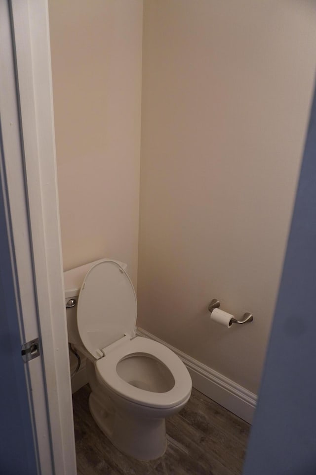 bathroom featuring wood-type flooring and toilet