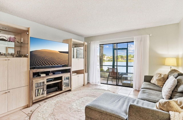 living room featuring light tile patterned floors and a textured ceiling