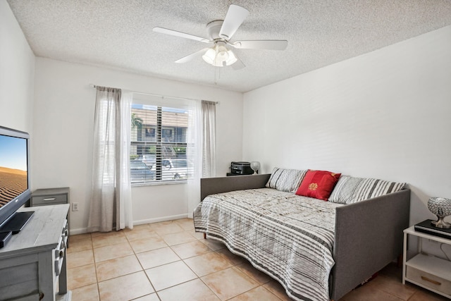 tiled bedroom featuring ceiling fan and a textured ceiling