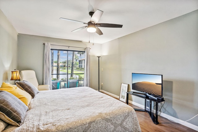 bedroom featuring access to outside, ceiling fan, and hardwood / wood-style floors